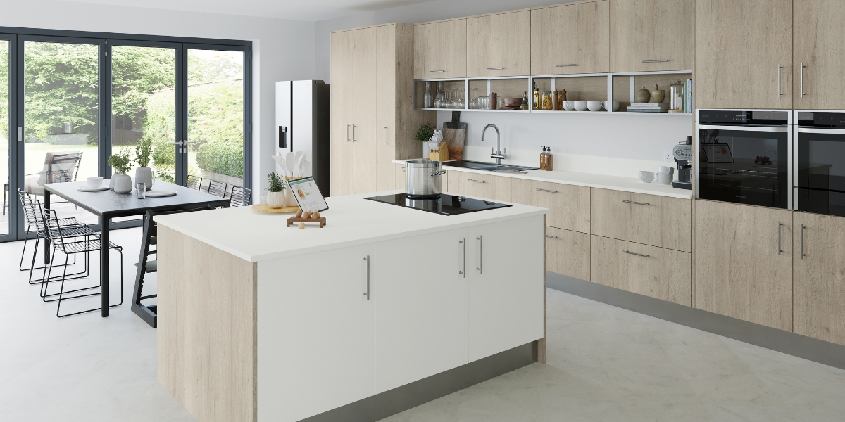 A large open plan kitchen diner in a white and oak finish.