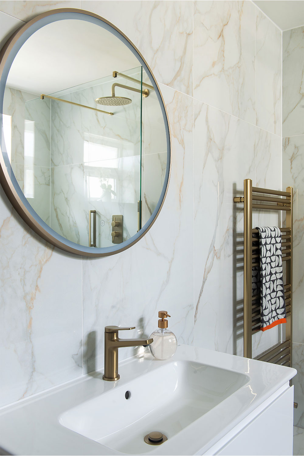 An illuminated mirror above a sink.