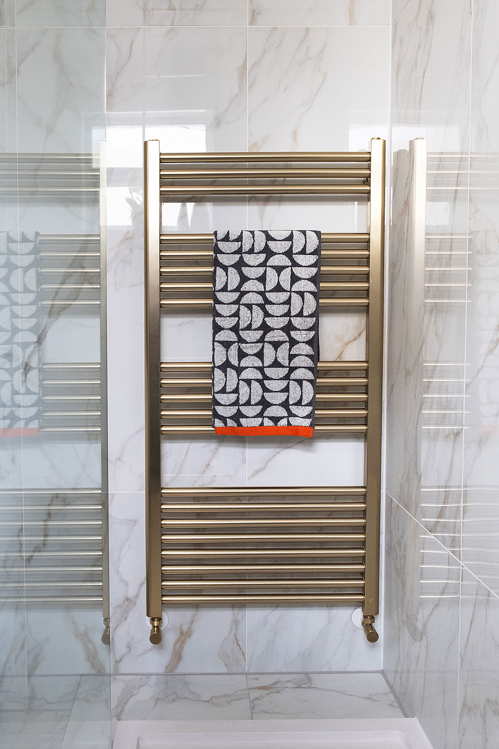 A brushed bronze towel warmer.