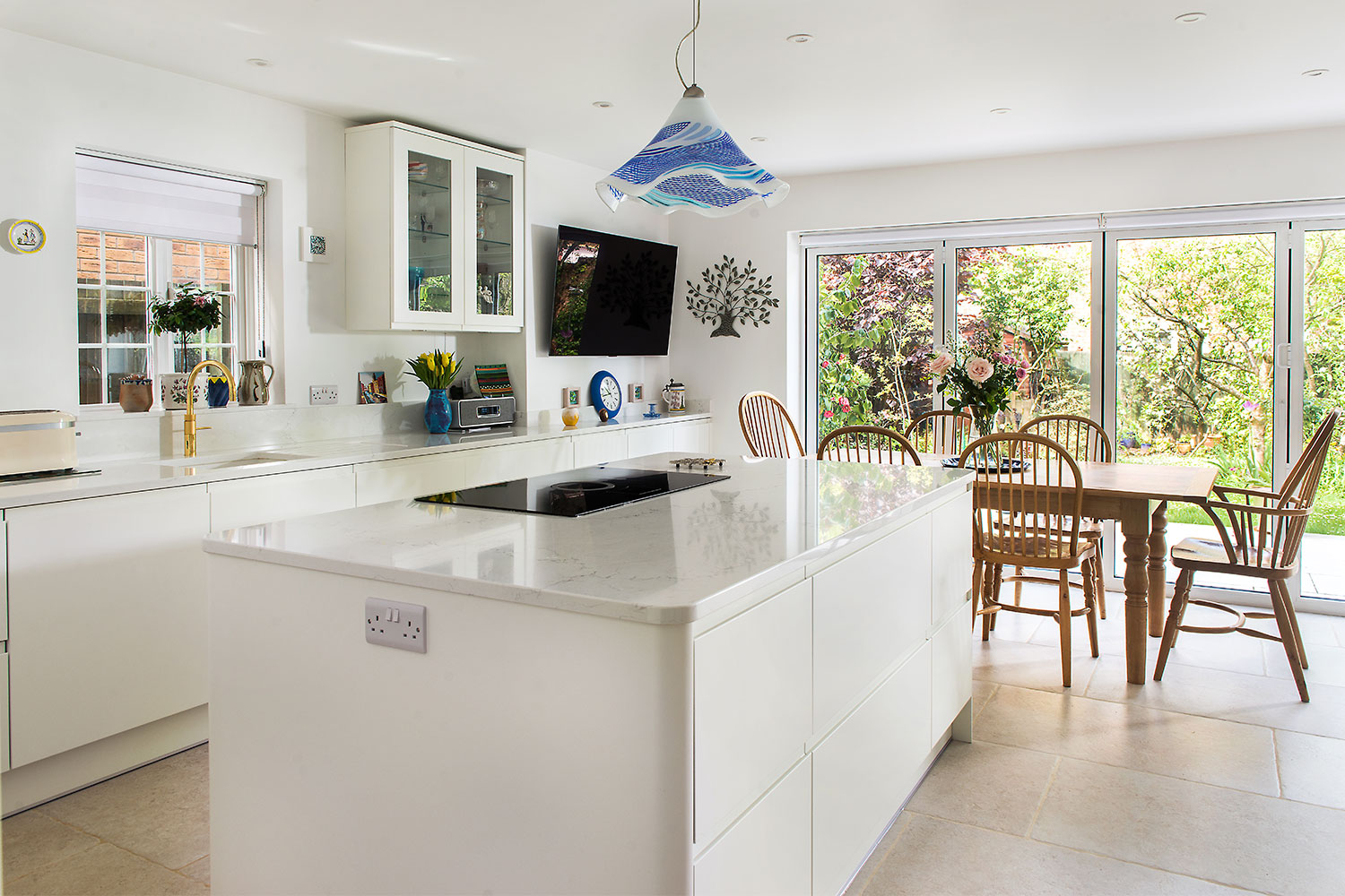 A bright white kitchen including kitchen island.
